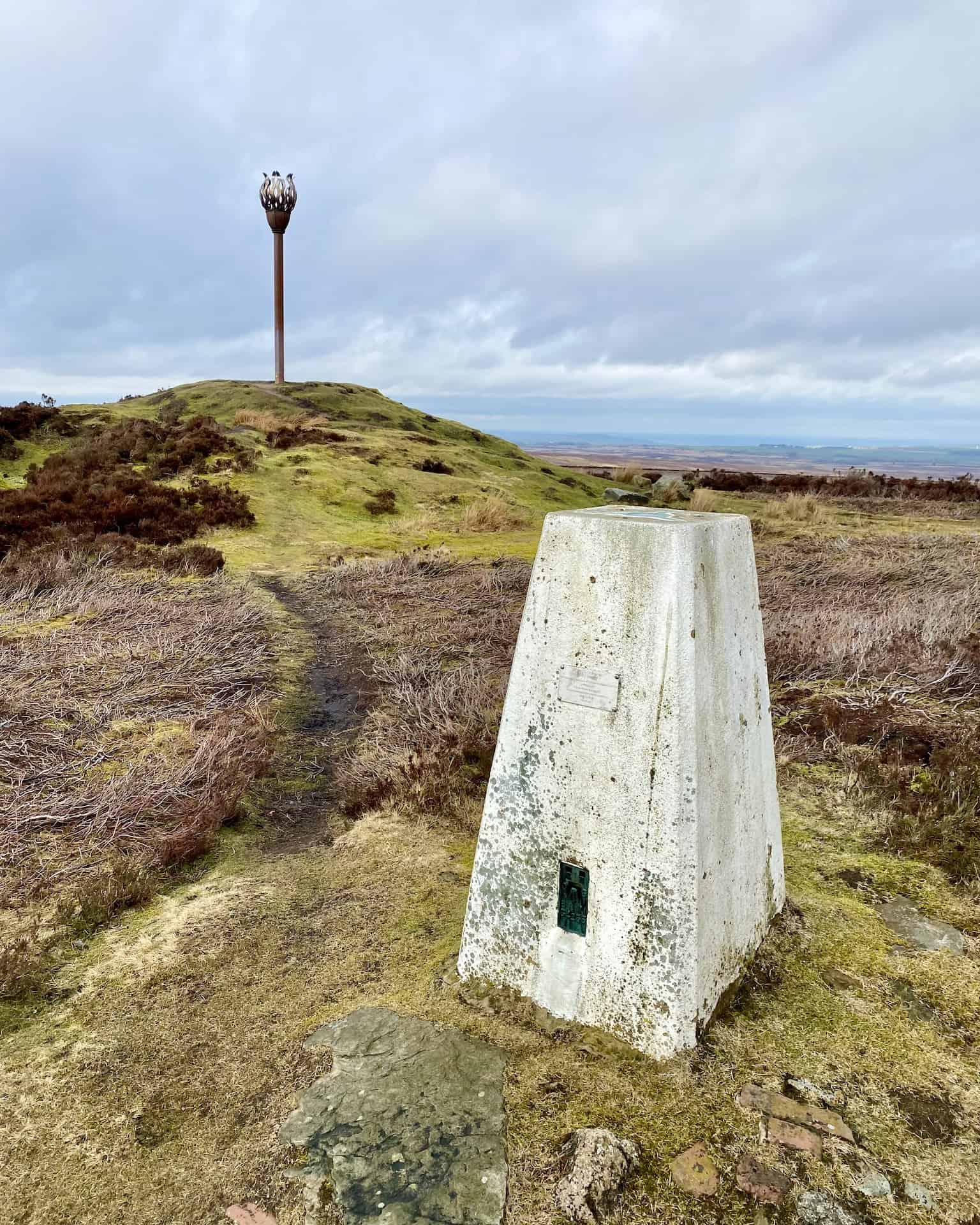 At the top of Beacon Hill, at a height of 299 metres (981 feet), is a triangulation pillar, or trig point. These concrete pillars, commonly seen in the United Kingdom, were historically used by surveyors to aid in the precise mapping of the country.