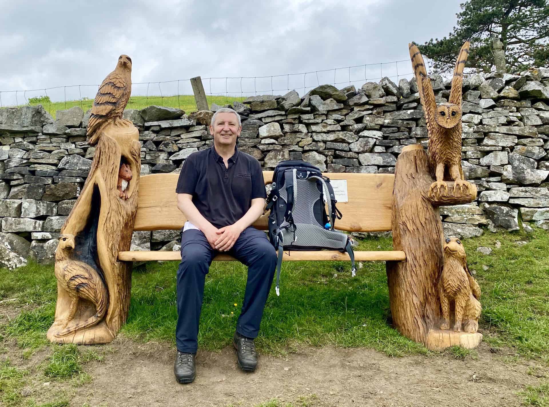 Time for a sit down at the end of a Wensleydale walk to Great Shunner Fell, Butter Tubs, and Fossdale. This comfortable and beautifully carved wooden memorial bench with great views of the village makes the ideal resting spot.