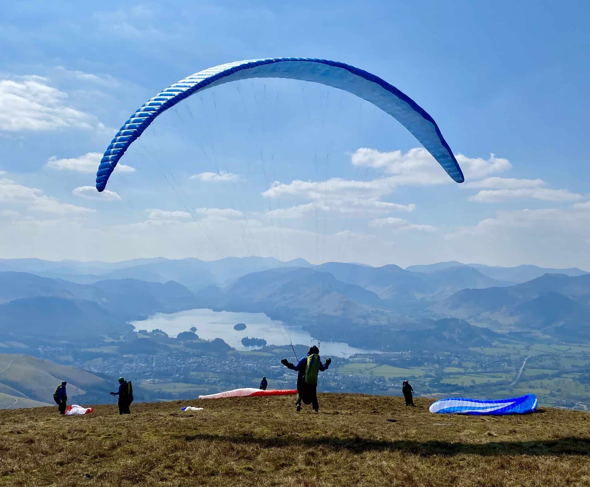 Paragliders on the south-western flanks of the Skiddaw mountain range, about a mile south-east of Little Man. In the background are Keswick and Derwent Water.
