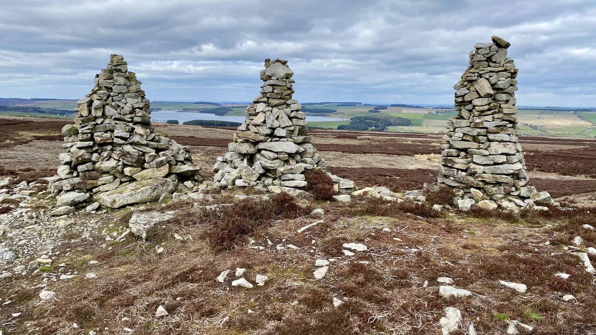 The Three Curricks, with Derwent Reservoir in the background. A currick is a Cumbrian word for what is more commonly known as a cairn, a man-made pile of stones used to guide travellers.