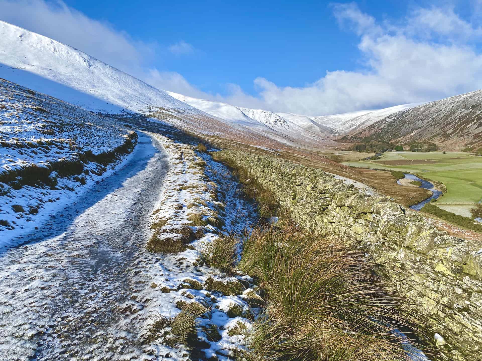 The River Caldew, visible over the wall, flows east through the valley between Bowscale Fell and Carrock Fell. It's source is high up on Skiddaw, between the summit and Sale How.