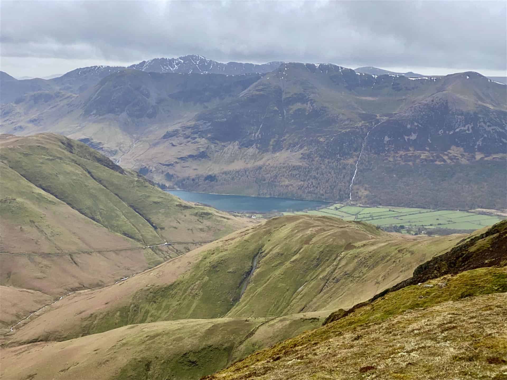 The view south from Wandope. The northern tip of Buttermere is visible in the valley below. The fells behind the lake include Red Pike, High Stile and High Crag.