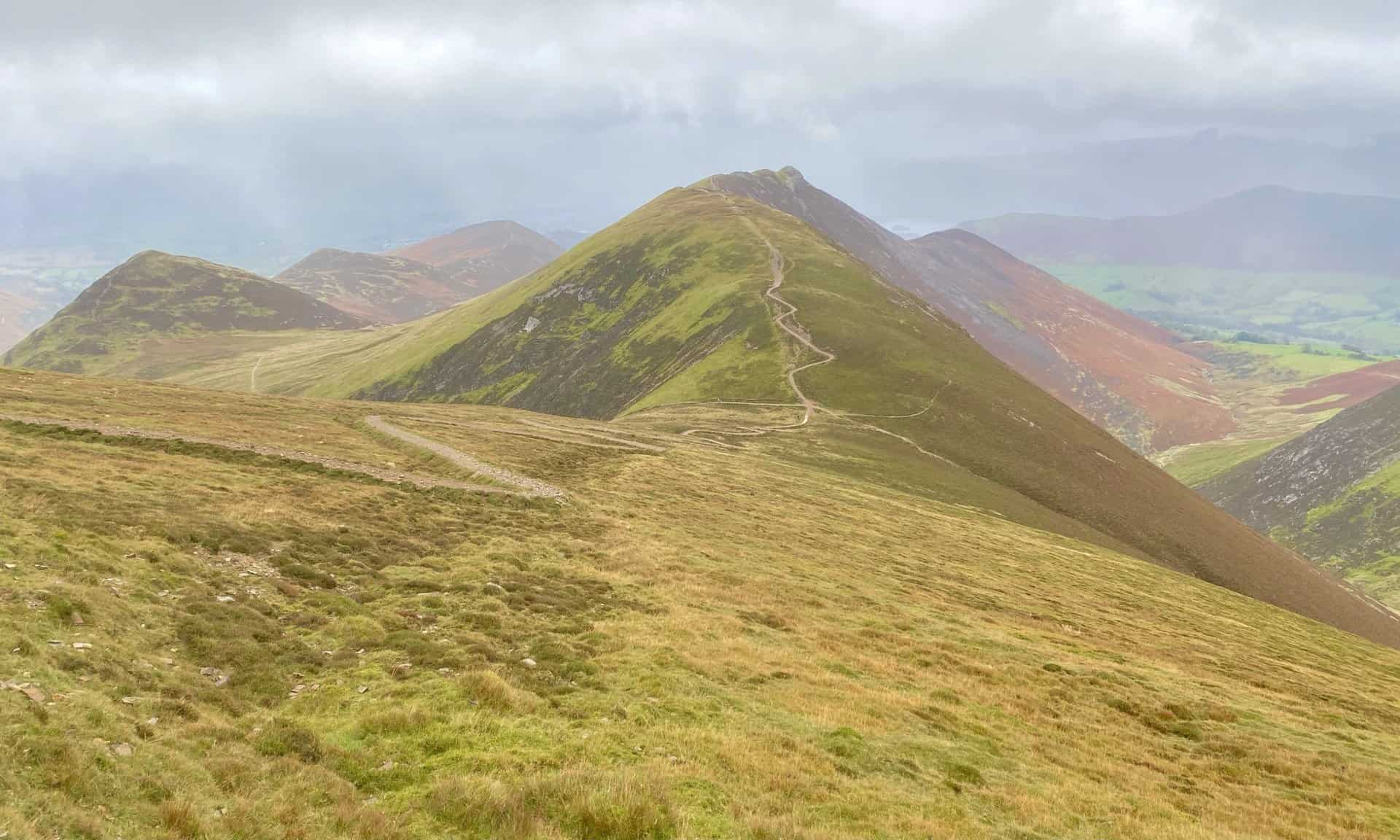 The winding, stone track down from Sail and up to Causey Pike. Behind Causey Pike is Rowling End. The three peaks on the left are Outerside, Stile End and Barrow. 