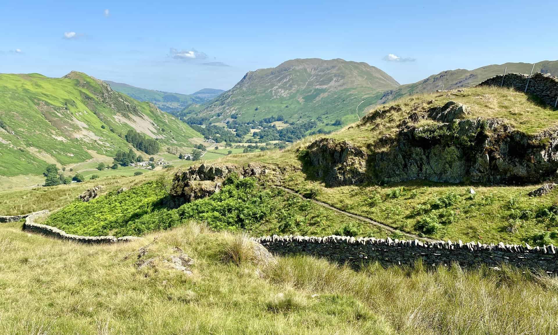 The view down to Deepdale and the valley floor between Patterdale and Hartsop. The huge mountain in the centre of the picture is Place Fell. To the left is Birks and Arnison Crag.
