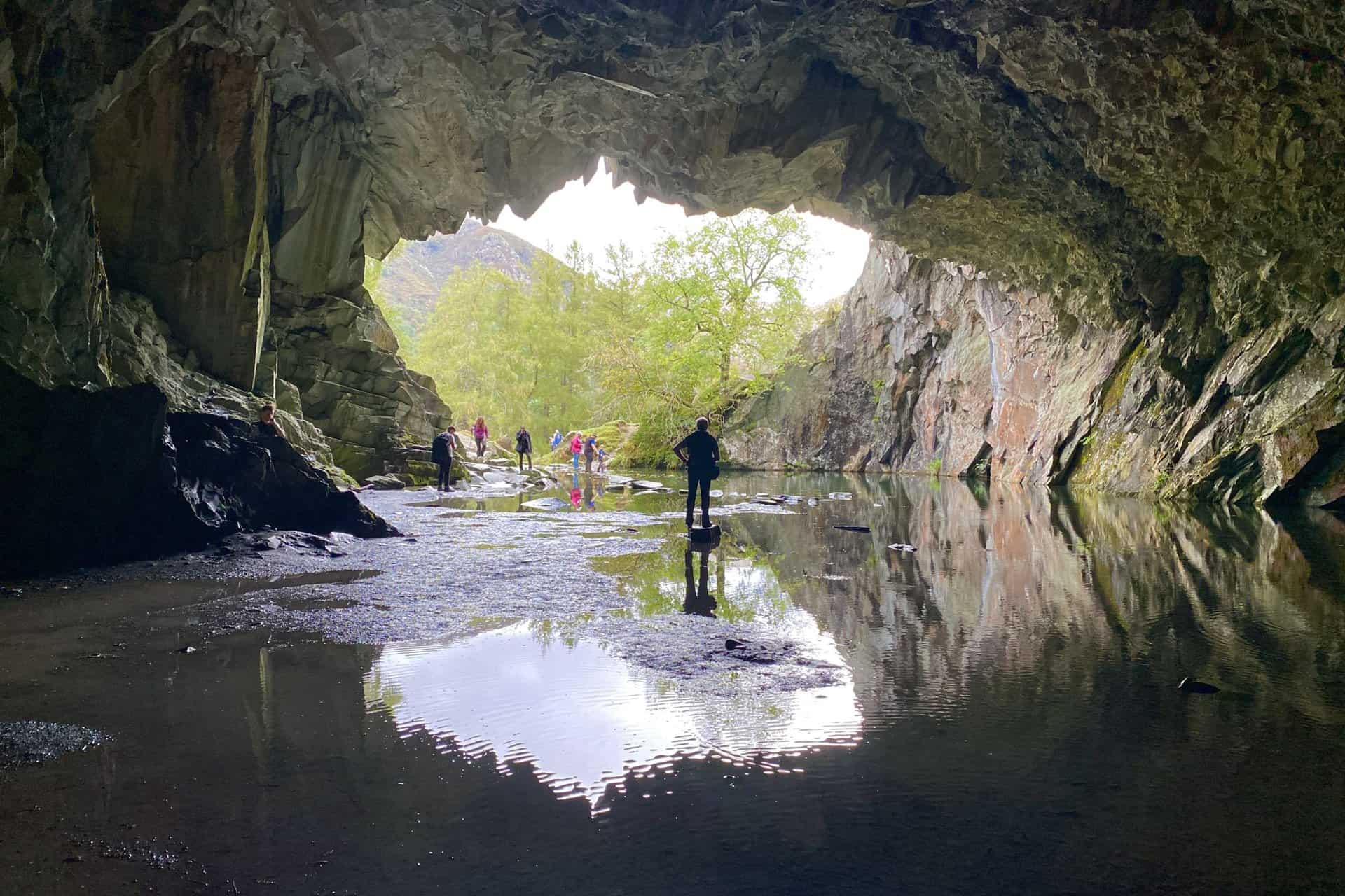 Rydal Cave. A man-made cave on the site of a former slate quarry, with stepping stones leading to a partially dry interior. One of the many highlights of the Loughrigg Fell walk.