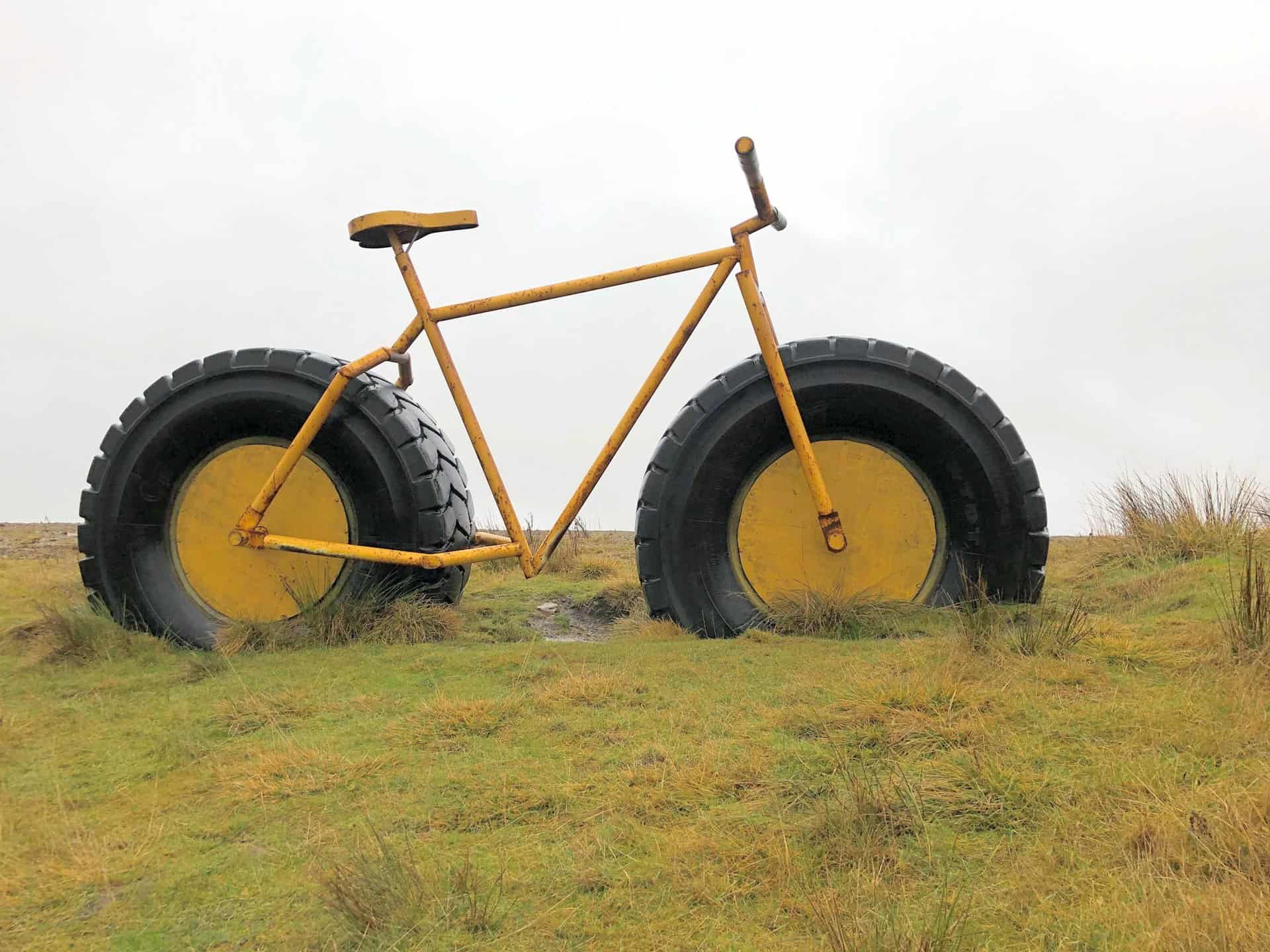Large yellow bicycle with tractor-sized tyres at Coldstones Cut.