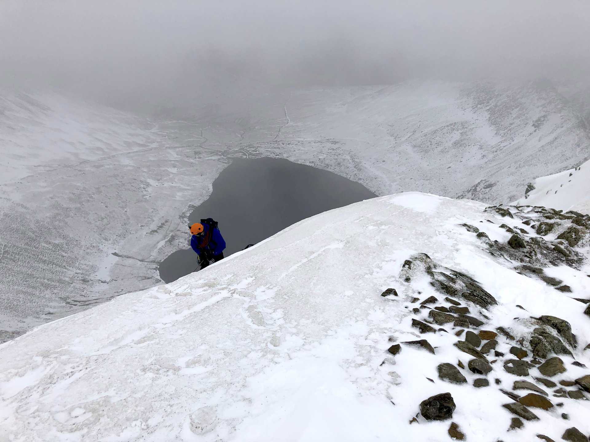 A climber's determination near Helvellyn’s peak, a poignant moment on the Helvellyn walk from Glenridding.