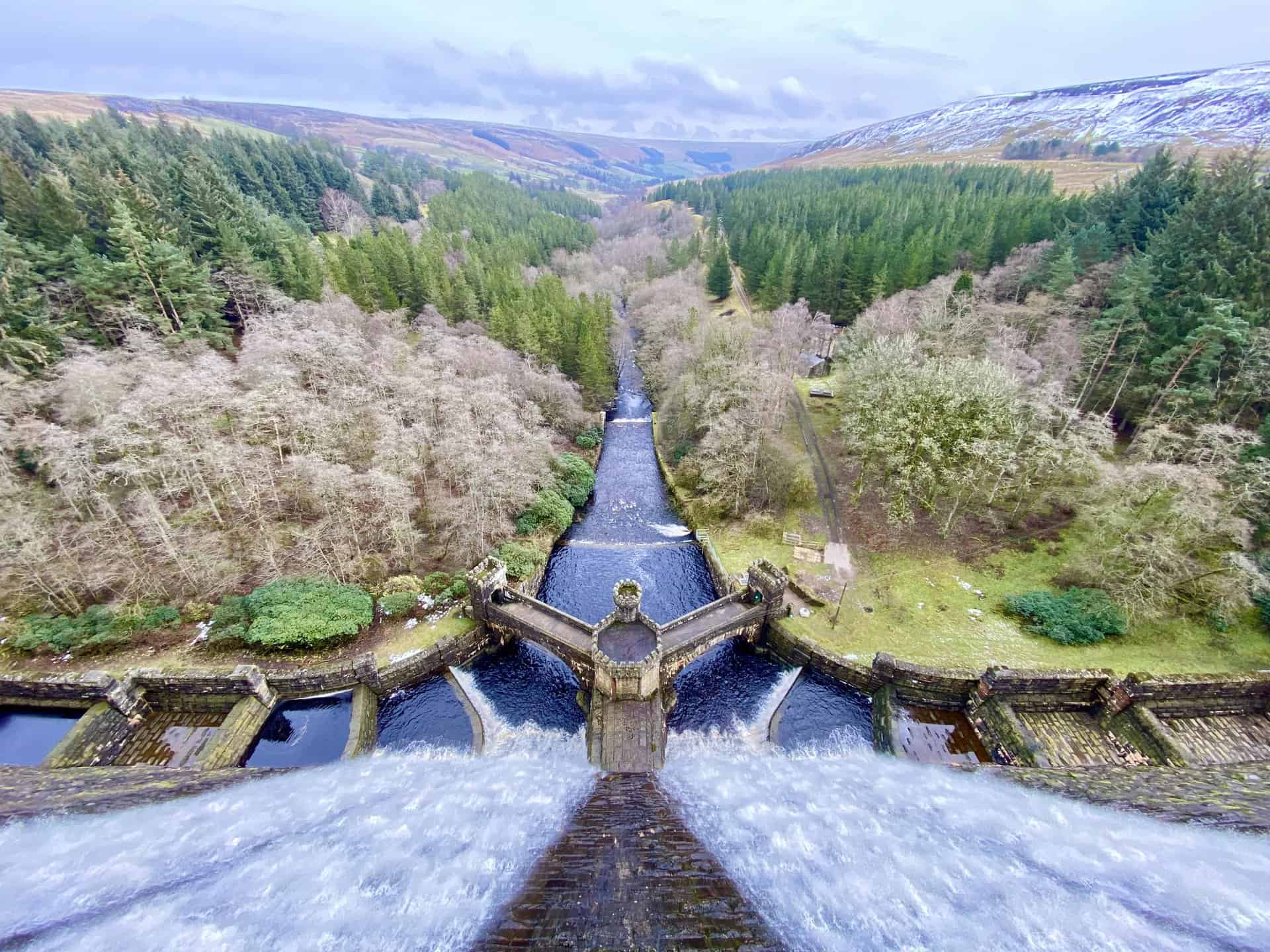 Waters cascading from the east side of the Scar House Reservoir dam, continuing their eastward flow through the Nidderdale valley.