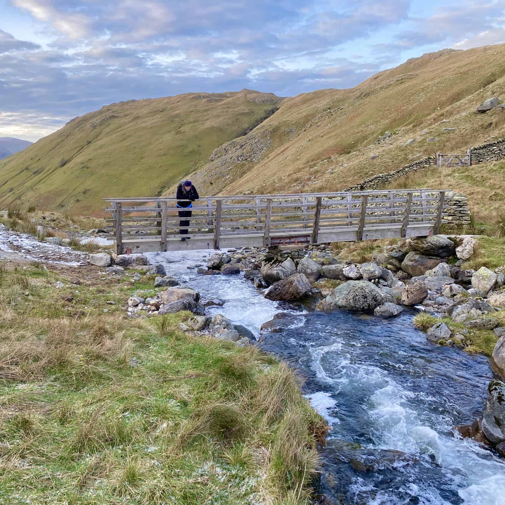 Footbridge across Hayeswater Gill, which flows west towards Hartsop. Along the way it merges with Pasture Beck and Kirkstone Beck and the resulting waters of Goldrill Beck head north and discharge into Ullswater.