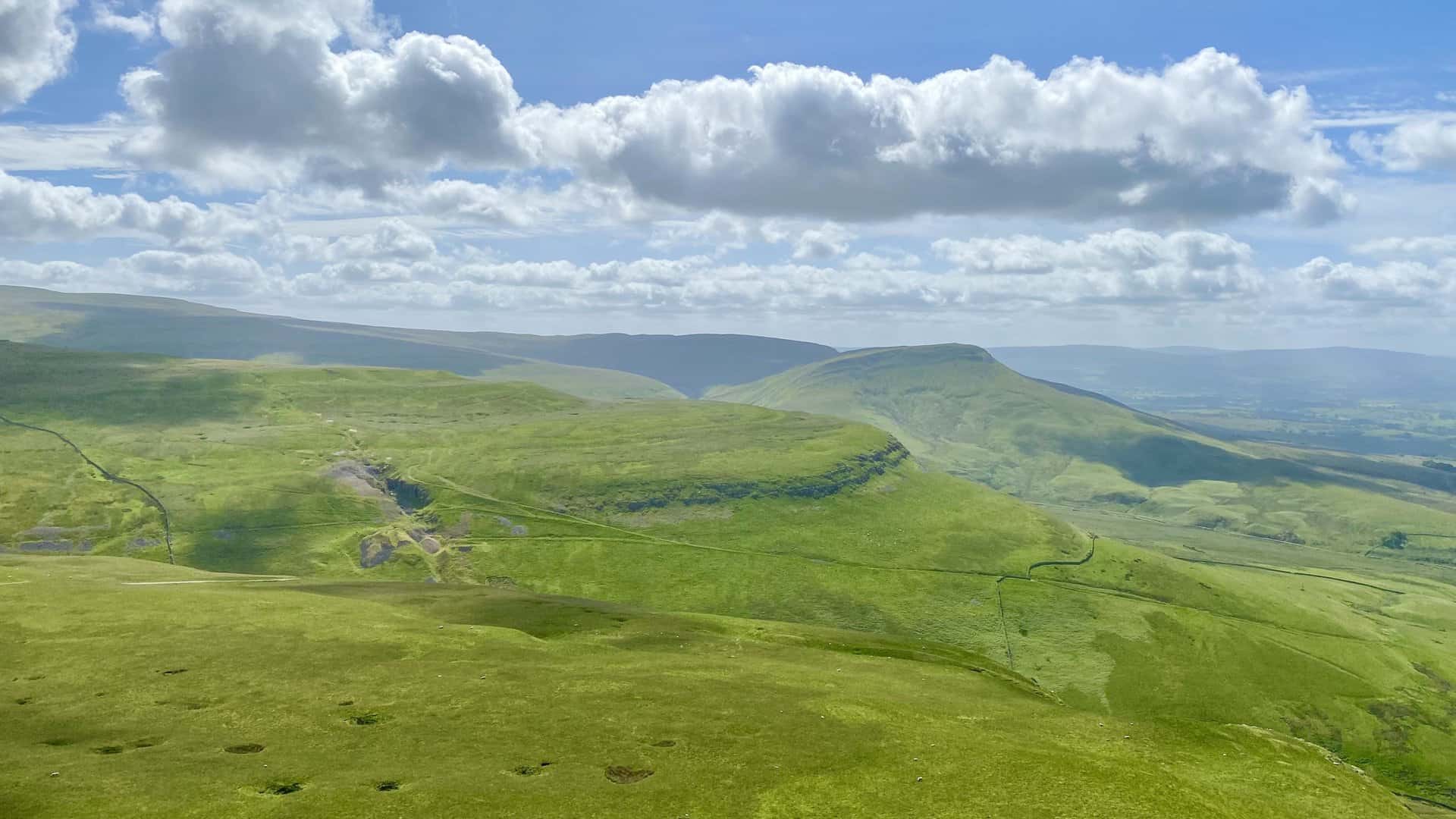The view south-east from Murton Pike towards Delfekirk Scar, with Roman Fell in the distance, becomes even more breathtaking on North Pennines walks that weave through this picturesque landscape.