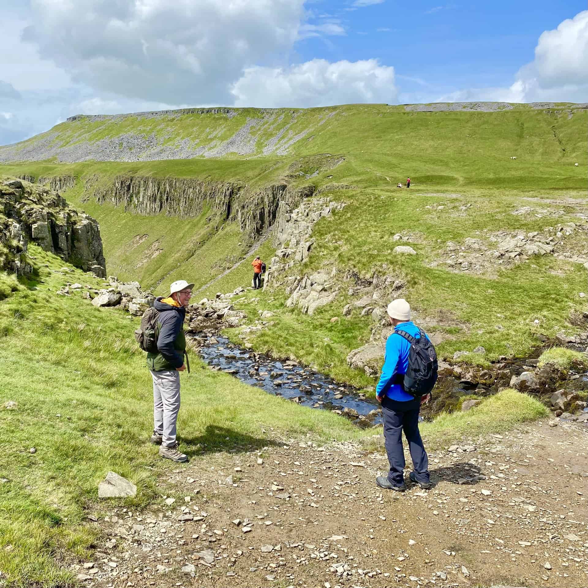 We reach High Cupgill Head where a small stream topples over the rocky crags into the valley below.