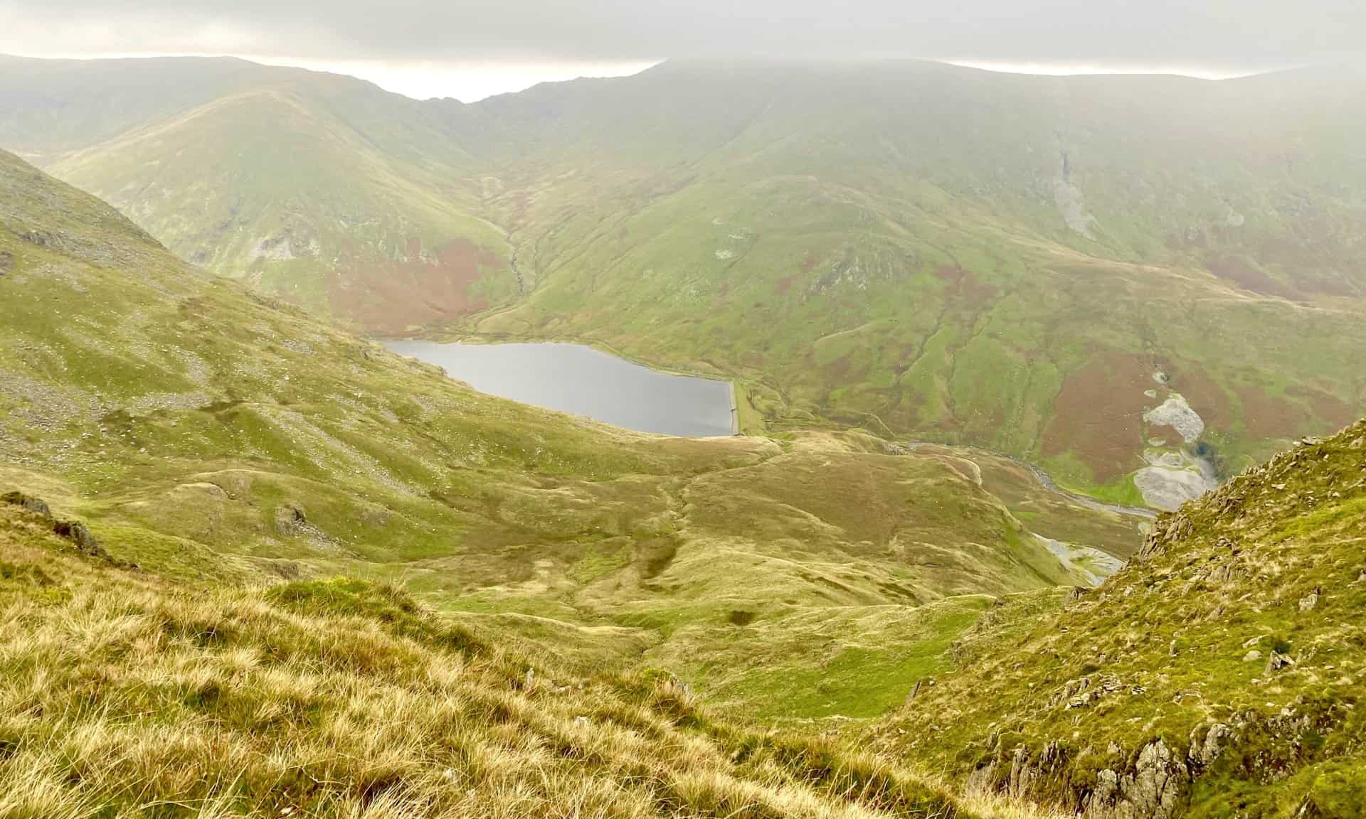 The view of Kentmere Reservoir from Yoke. Behind the reservoir Lingmell Gill flows down through the valley between Mardale Ill Bell (horizon, left) and Harter Fell (cloud-covered, right).