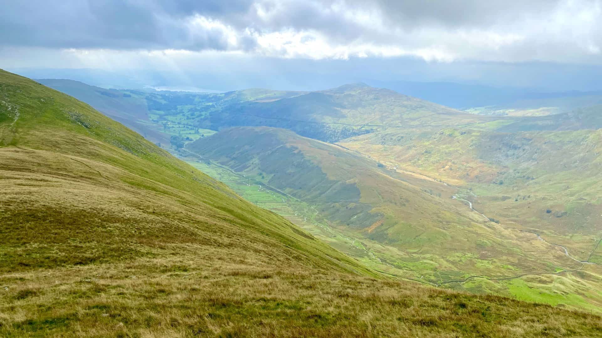 The view south-west from Froswick. The high ground in the middle of the wide valley is The Tongue, with Hagg Gill flowing on its left (east) side and Trout Beck on its right (west) side. The pointed fell in the distance is Wansfell.