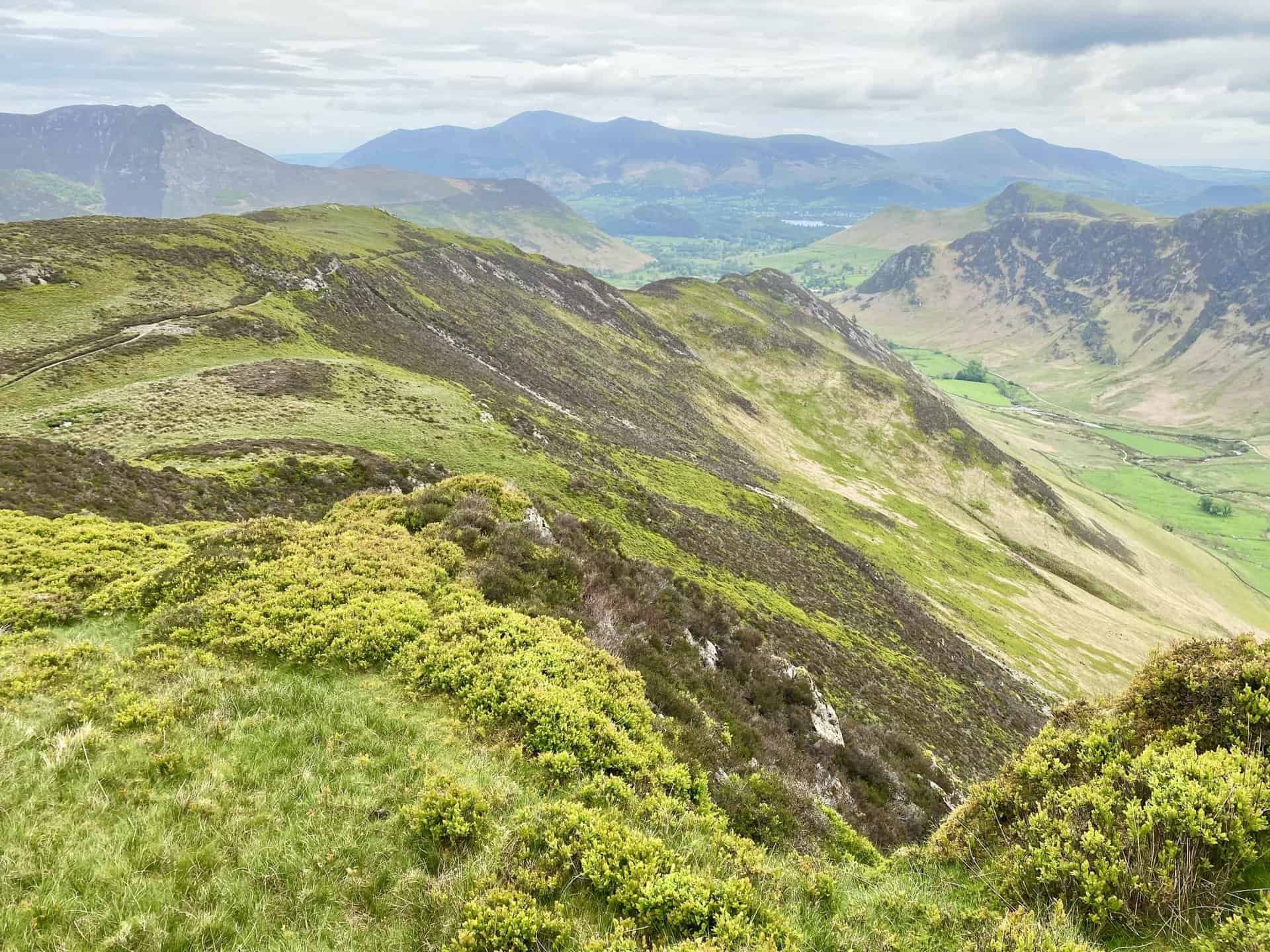 Looking back at High Crags and Scope End, with the Skiddaw and Blencathra mountain ranges in the distance.