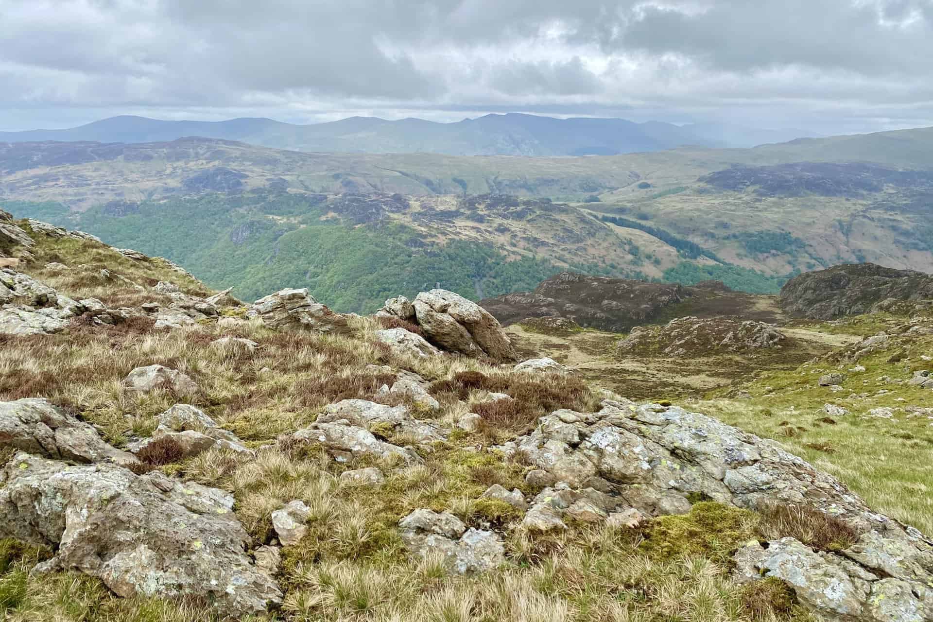 The view east from Minum Crag towards the Helvellyn mountain range in the distance on the horizon.