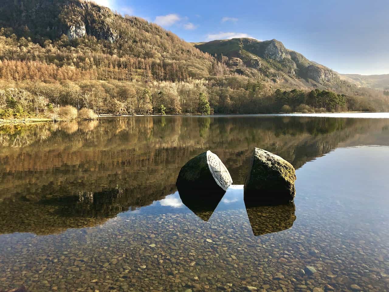 The Centenary Stone in Calfclose Bay, a large split boulder commemorating 100 years of the National Trust in the Lake District. This intriguing landmark is a highlight on the Derwent Water circular walk.