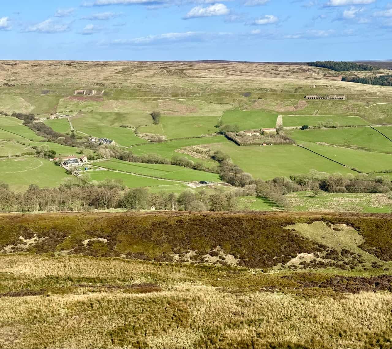 The eastward view across the valley floor towards the section of the old railway line showcases the Iron Kilns (to the left) and the Stone Kilns (to the right) in the photograph’s upper third, illustrating the industrial heritage of the area.