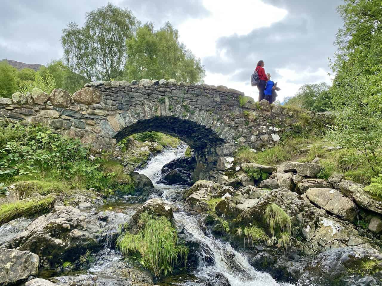 Ashness Bridge, a traditional stone-built packhorse bridge striding Barrow Beck. This location is a highlight of the Walla Crag walk.