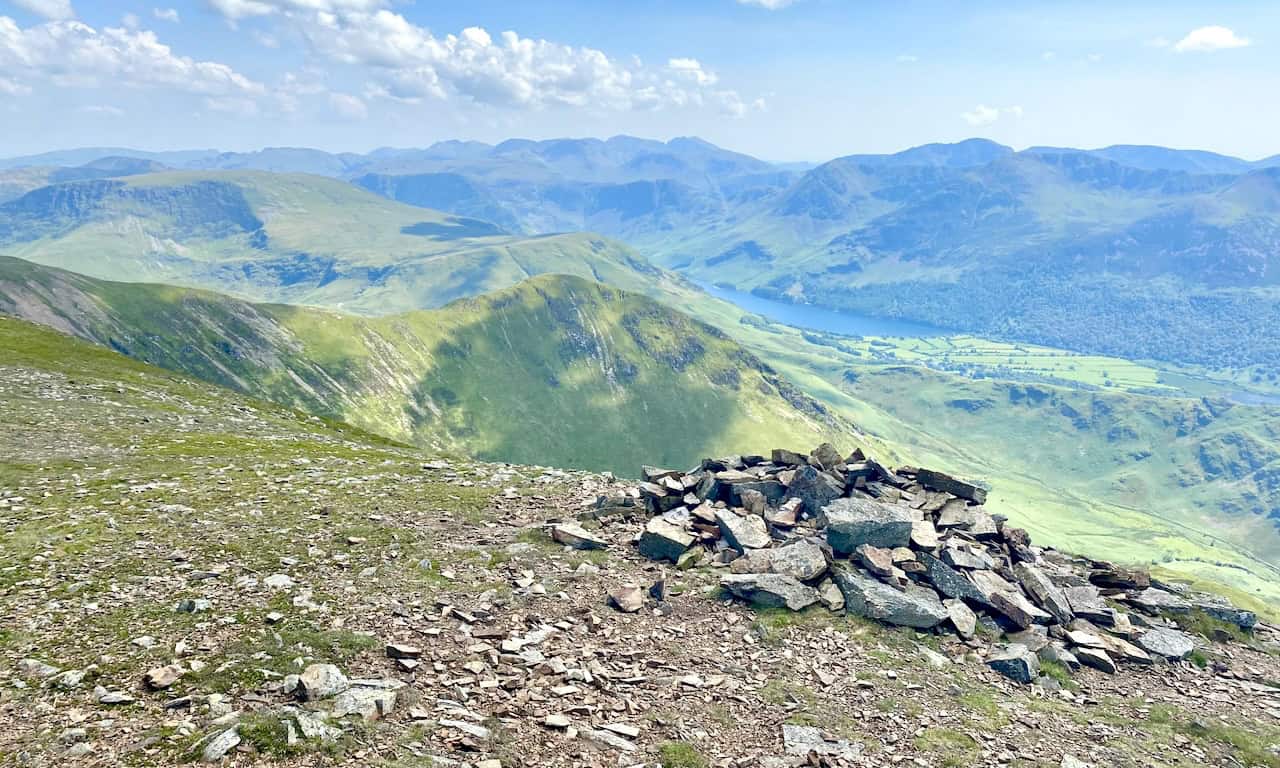 Looking south from Grasmoor towards Whiteless Pike, High Snockrigg and, in the far distance on the horizon, the mountain range which includes Sca Fell and Scafell Pike.