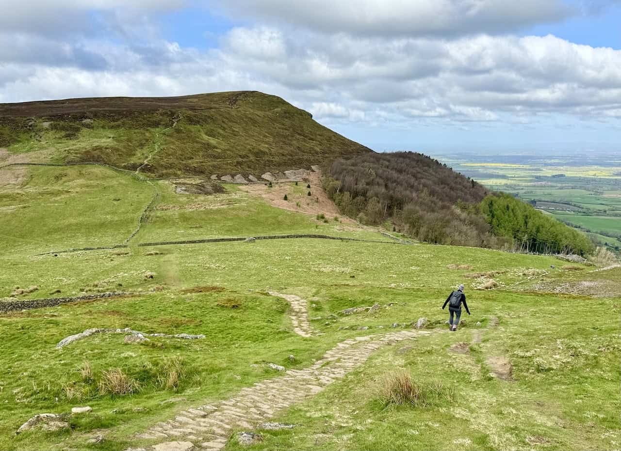 Continuing west down the stone track towards Garfit Gap, nestled between Wainstones and Cold Moor. The next climb, up to the top of Cold Moor, is clearly visible, as is the alternative path around the northern side of the hill for those who prefer not to ascend to the summit.