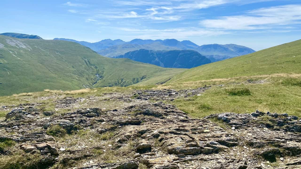 The view south from the Robinson plateau close to its summit. In the far distance on the horizon are the mountains in the Scafell Pike region, like Sca Fell, Scafell Pike, Great Gable, Ill Crag and Great End.