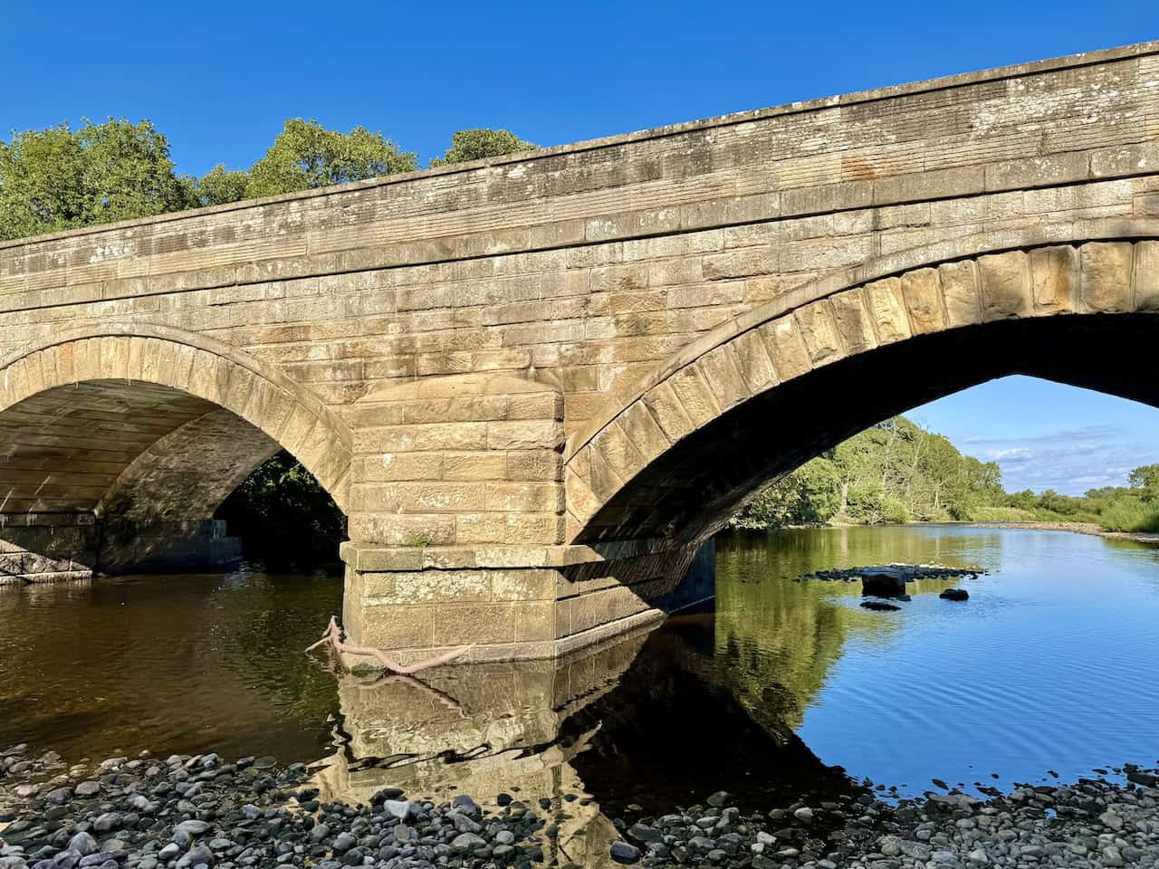 Wensley Bridge glows in the afternoon sun at the end of a varied circular walk.
