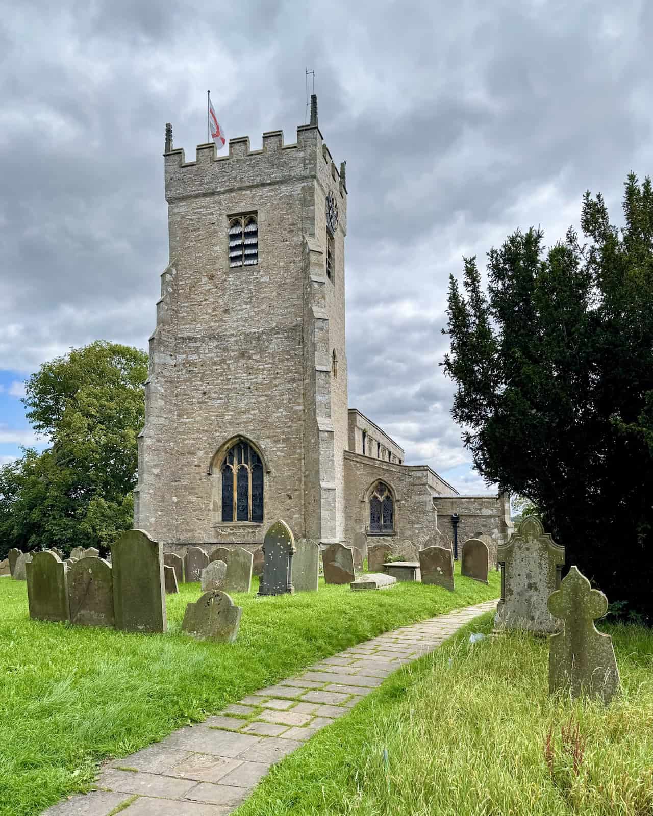 A path beside a play area leads into a churchyard on the Tupgill Park walk. This is about a quarter of the way round the Tupgill Park walk.
