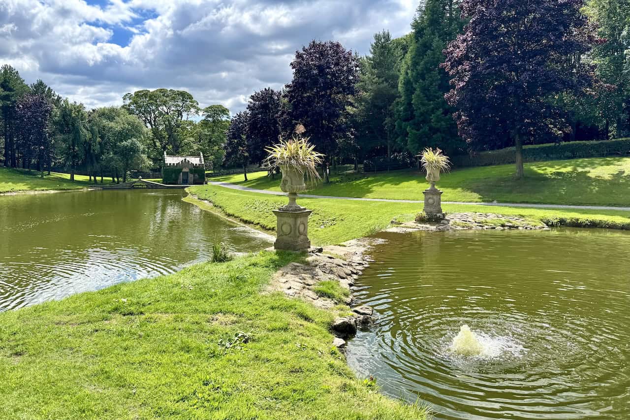 Stone statues and lawns surround ornamental ponds on the Tupgill Park walk.
