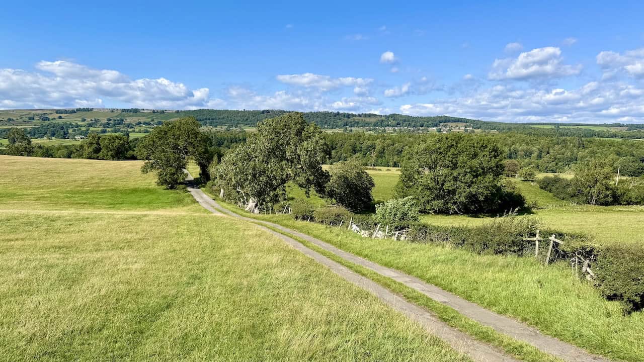 Flats Lane descends gently across grassy fields towards Preston-under-Scar.
