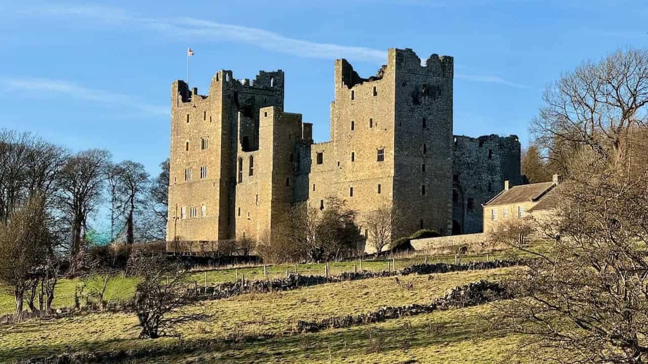 Bolton Castle overlooking open moorland and villages on the Bolton Castle walk in Wensleydale.