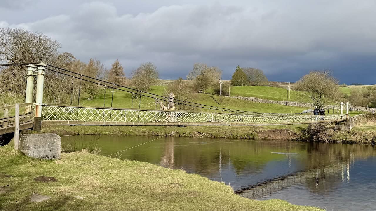 A view back across Hebden Suspension Bridge from the southern bank of the River Wharfe on the Grassington circular walk.
