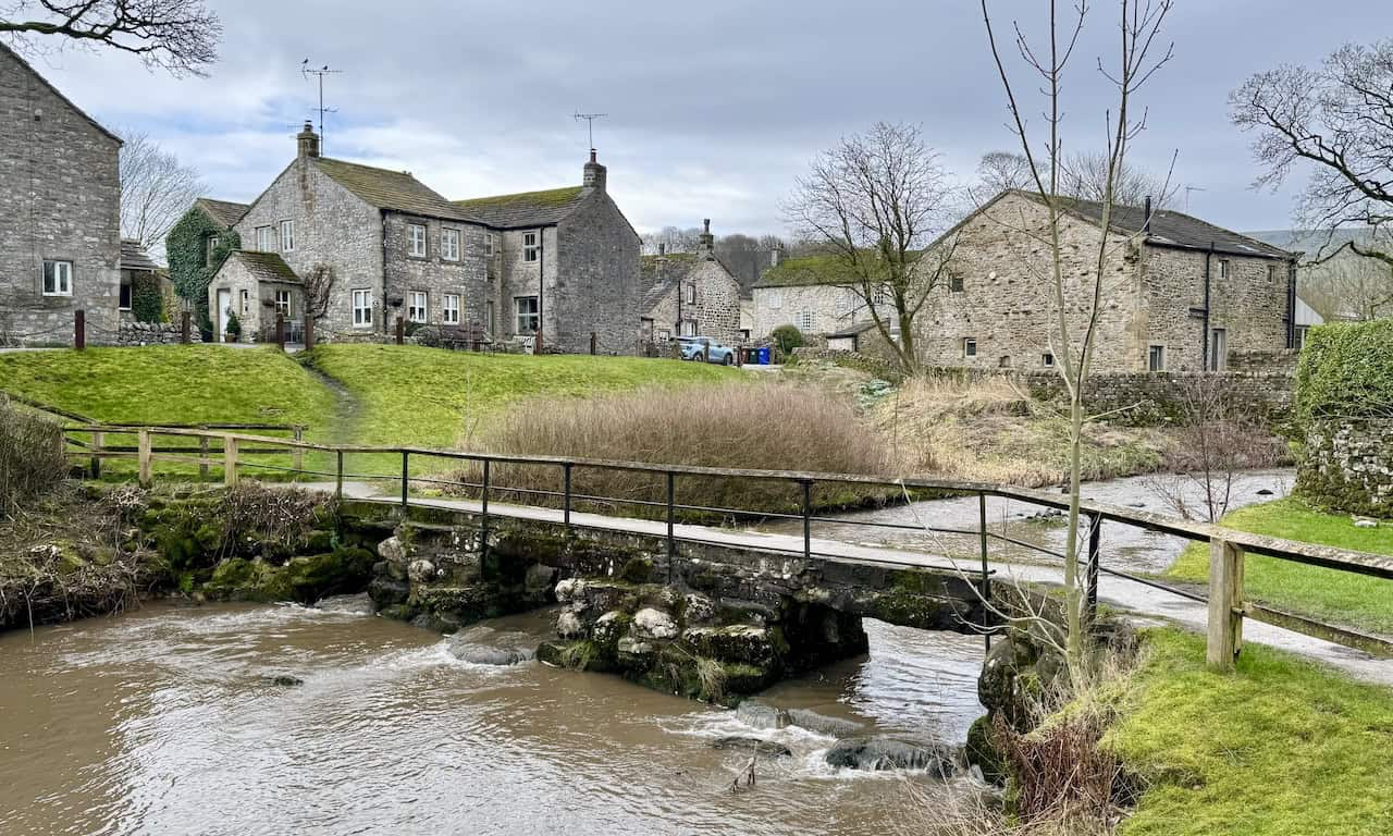 A stone-arched bridge crossing Linton Beck on the village green in Linton, one of two Grade II listed bridges that make for one of the most photographed scenes in Upper Wharfedale.