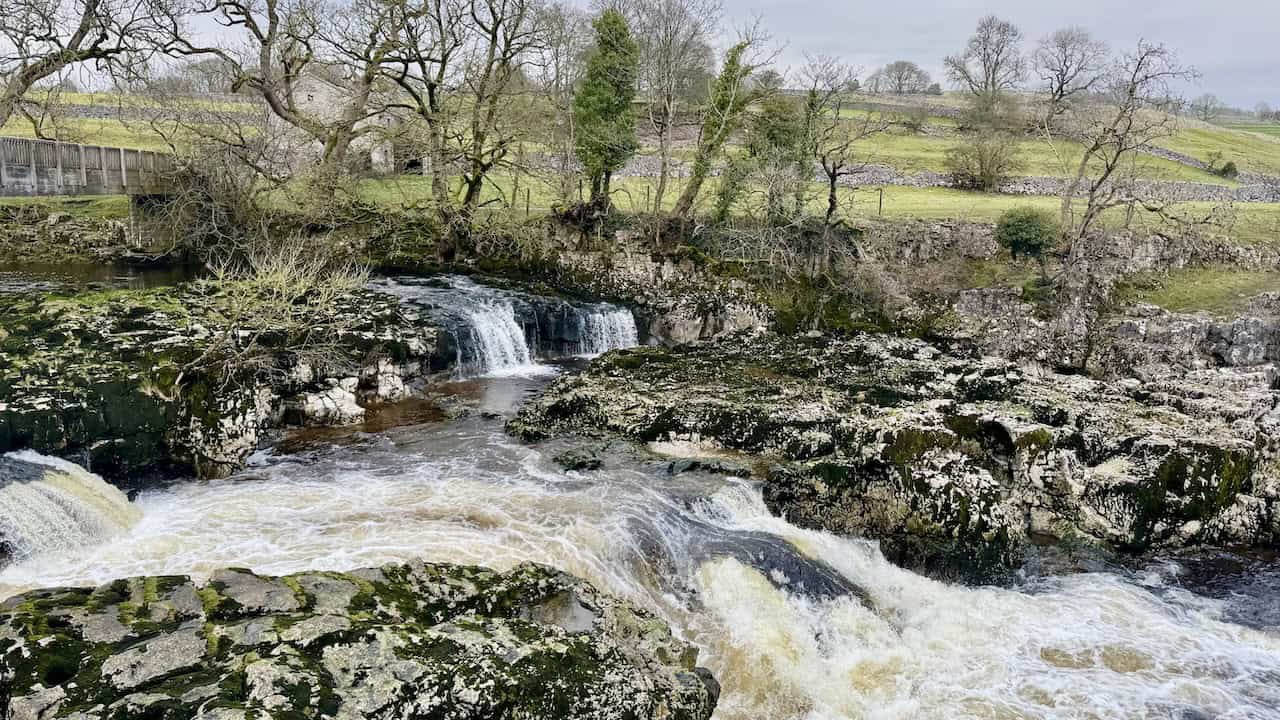 A view of Linton Falls on the River Wharfe, where the water thunders over limestone rocks formed by a geological fault that shifted millions of years ago.