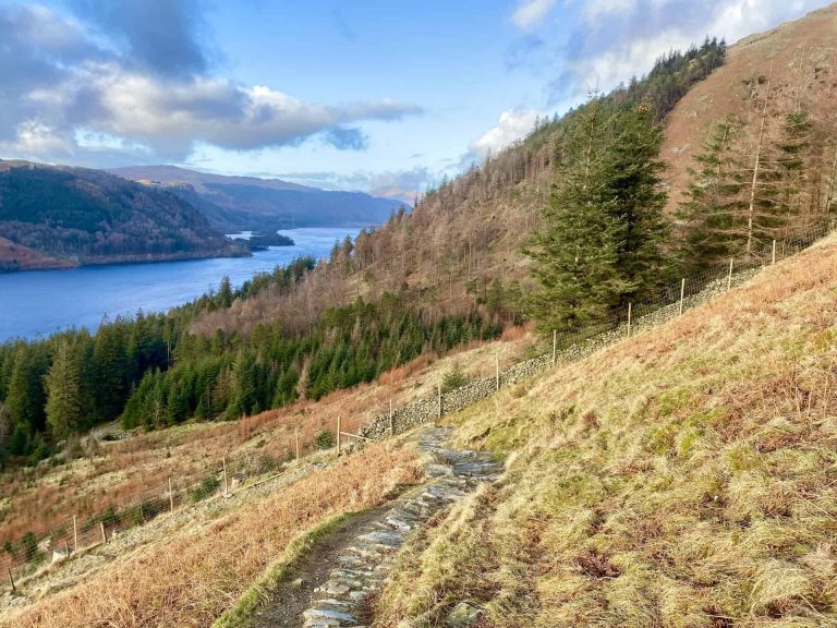Helvellyn from Swirls path descending into woodland near Wythburn from Comb Crags.