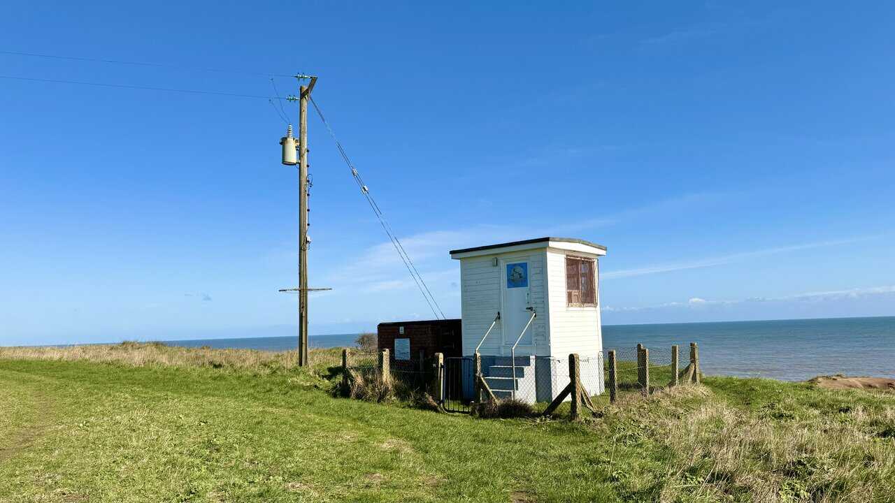 Long Nab Coastguard Station and Mine Shelter on the clifftop during the Cloughton Wyke walk, with open sea views and the historic brick shelter beside the station.