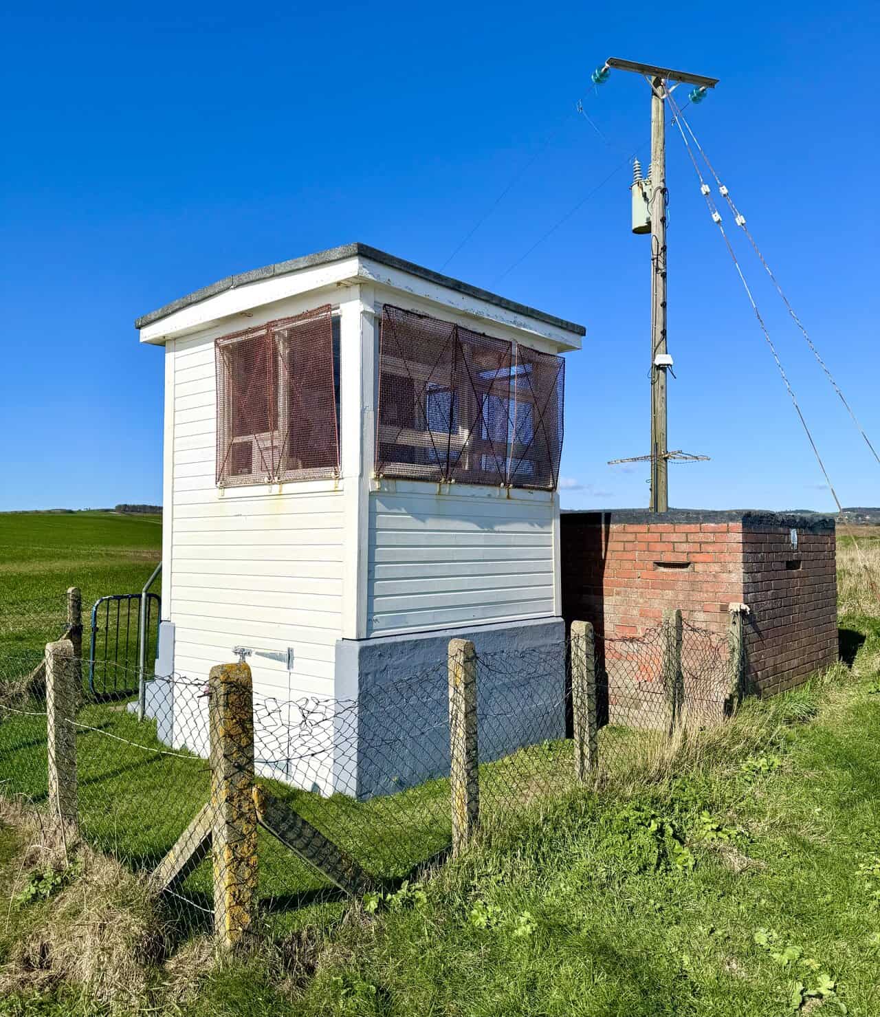 Rear view of the former coastguard station, with observation windows now used by birdwatchers studying migration on this peaceful stretch of coast.