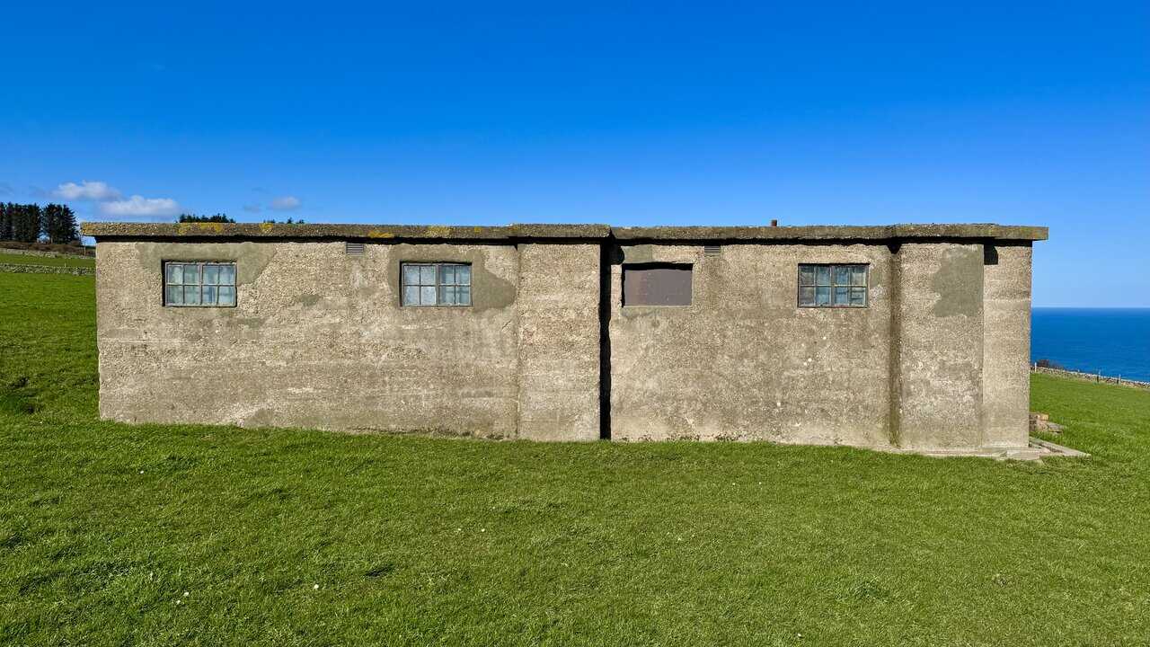Transmitter and Receiver Block at Ravenscar radar station, a reinforced concrete and brick building with a flat roof.