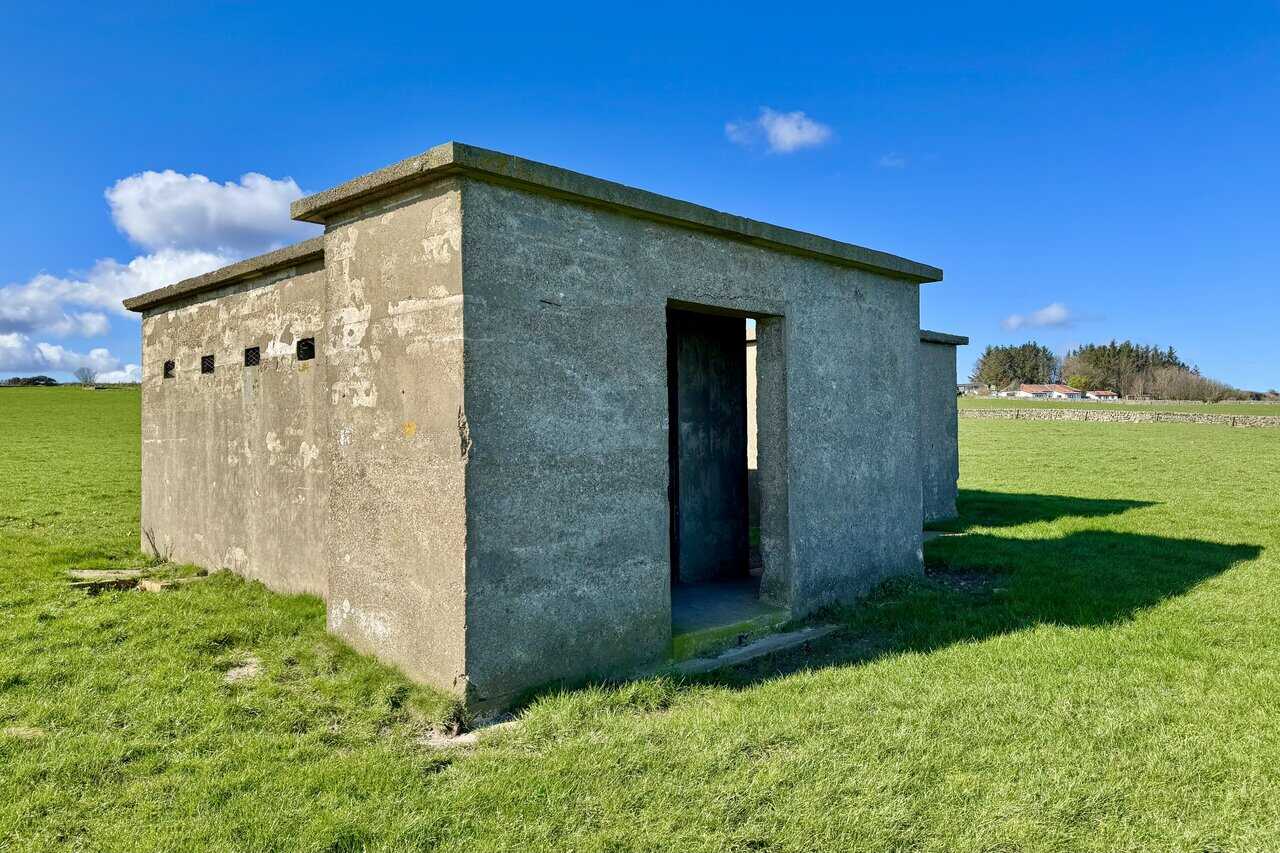 Engine House at Ravenscar radar station, a concrete building with a flat roof and screened porch.