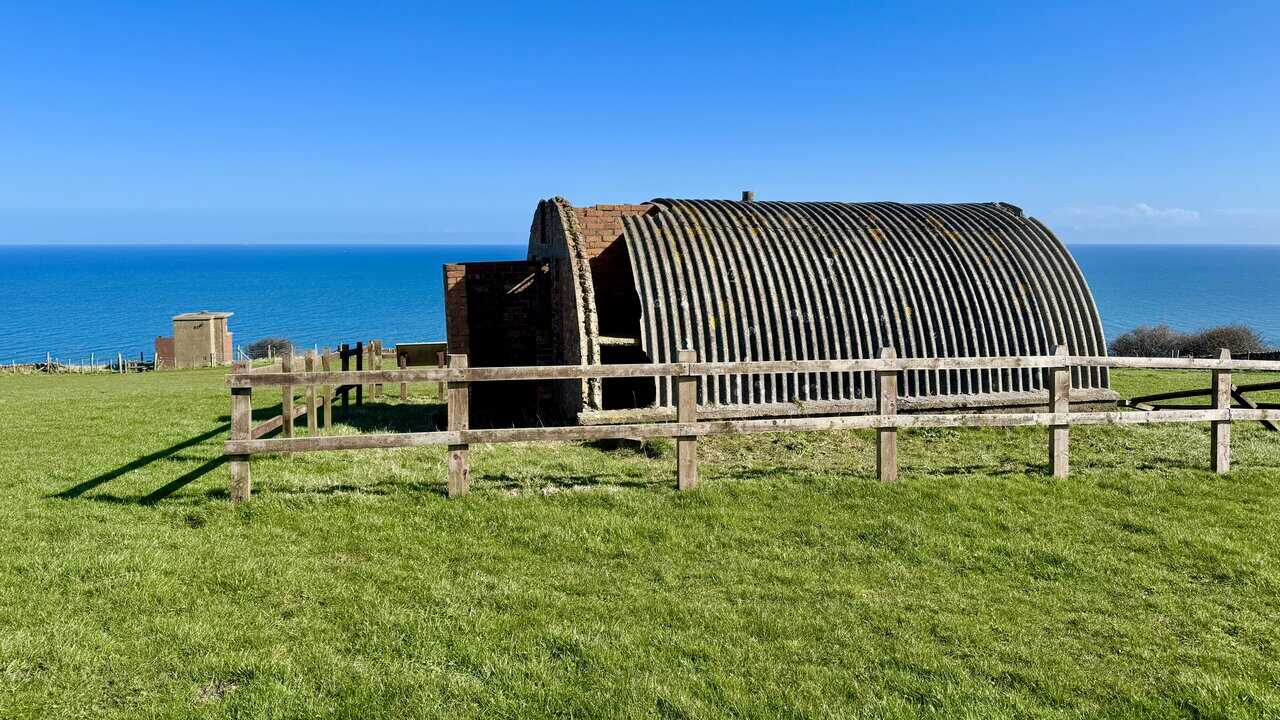 Historic radar station building at Ravenscar with open coastal views behind.