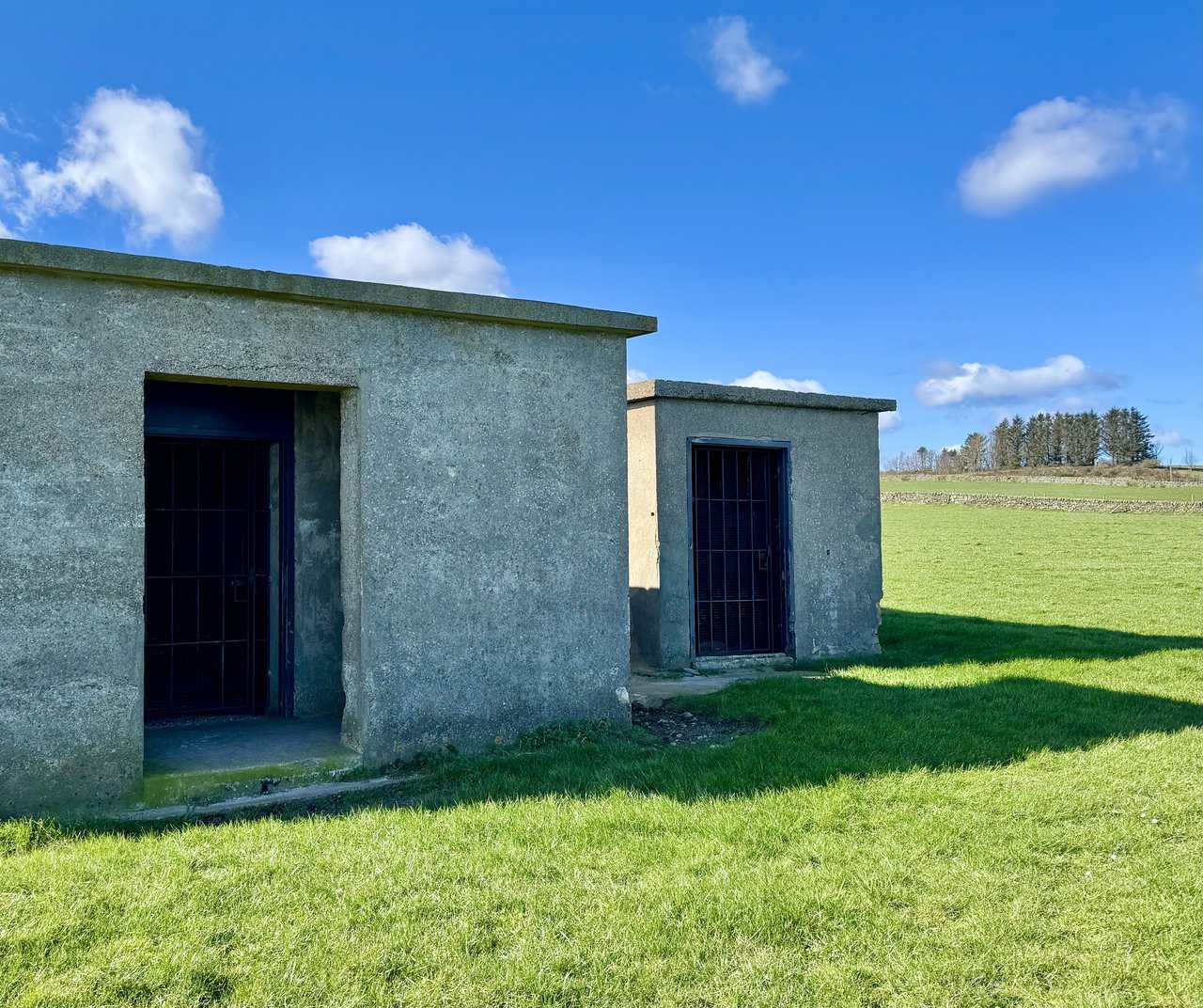 Radar station buildings standing in open coastal grassland at Ravenscar.