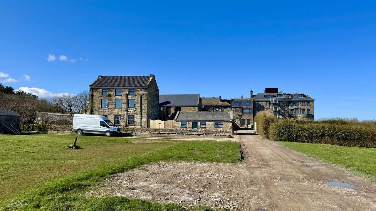 Rear view of the historic Raven Hall Hotel standing in clifftop grounds above Robin Hood’s Bay.