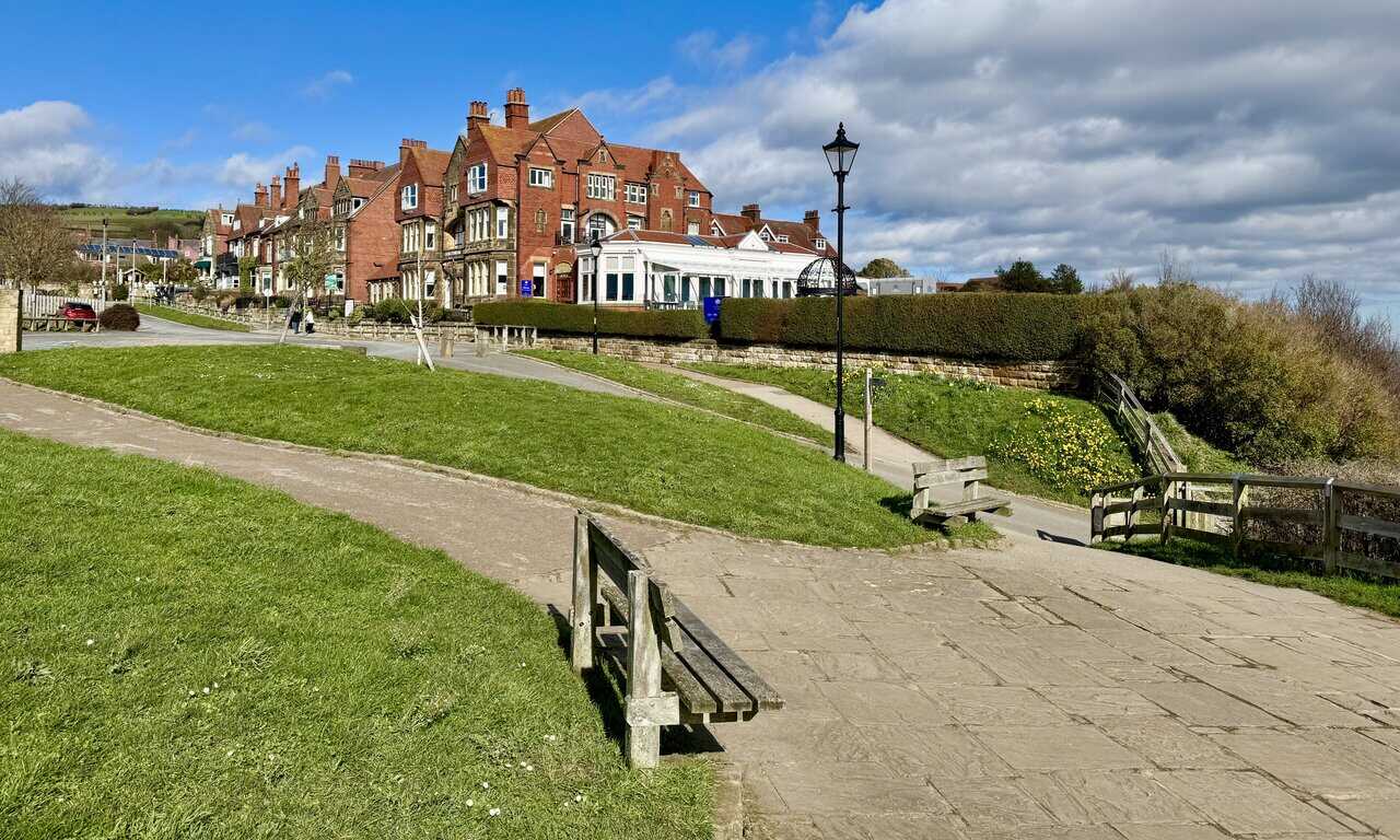 Small village green near the top of Robin Hood’s Bay, with benches, spring daffodils and space to sit and rest.