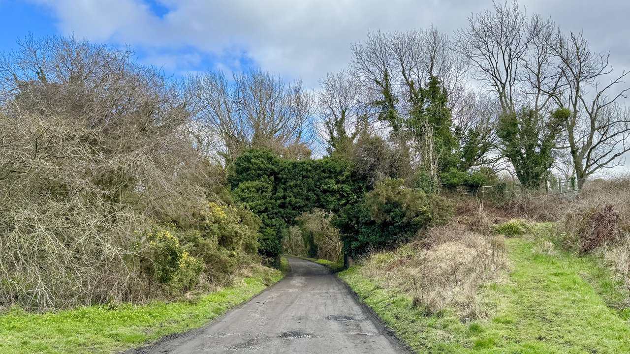 Former railway path of the Cinder Track stretching into the distance, recalling the old coastal railway between Scarborough and Whitby.