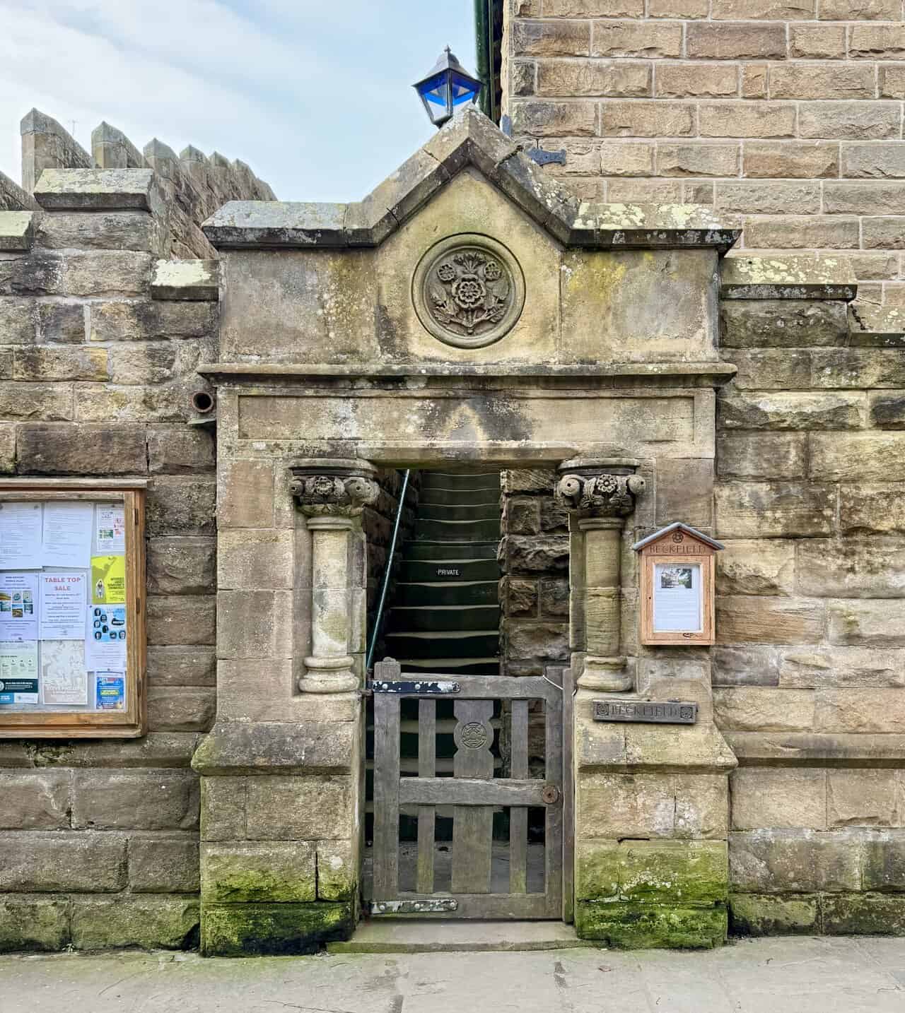 Ornate stone doorway at Beckfield with carved columns and a rose motif above the entrance.
