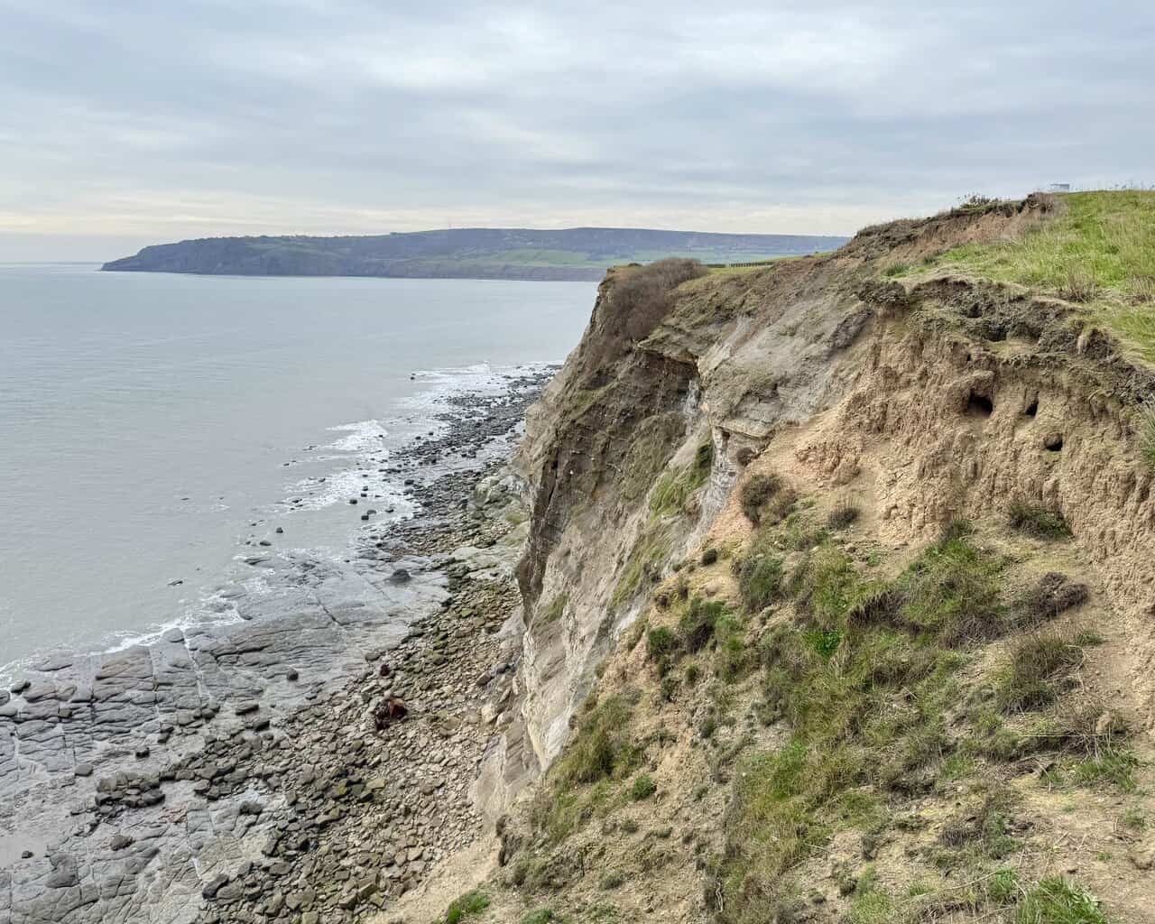 Eroded cliffs and rock platforms stretching south towards Ravenscar from Ness Point.