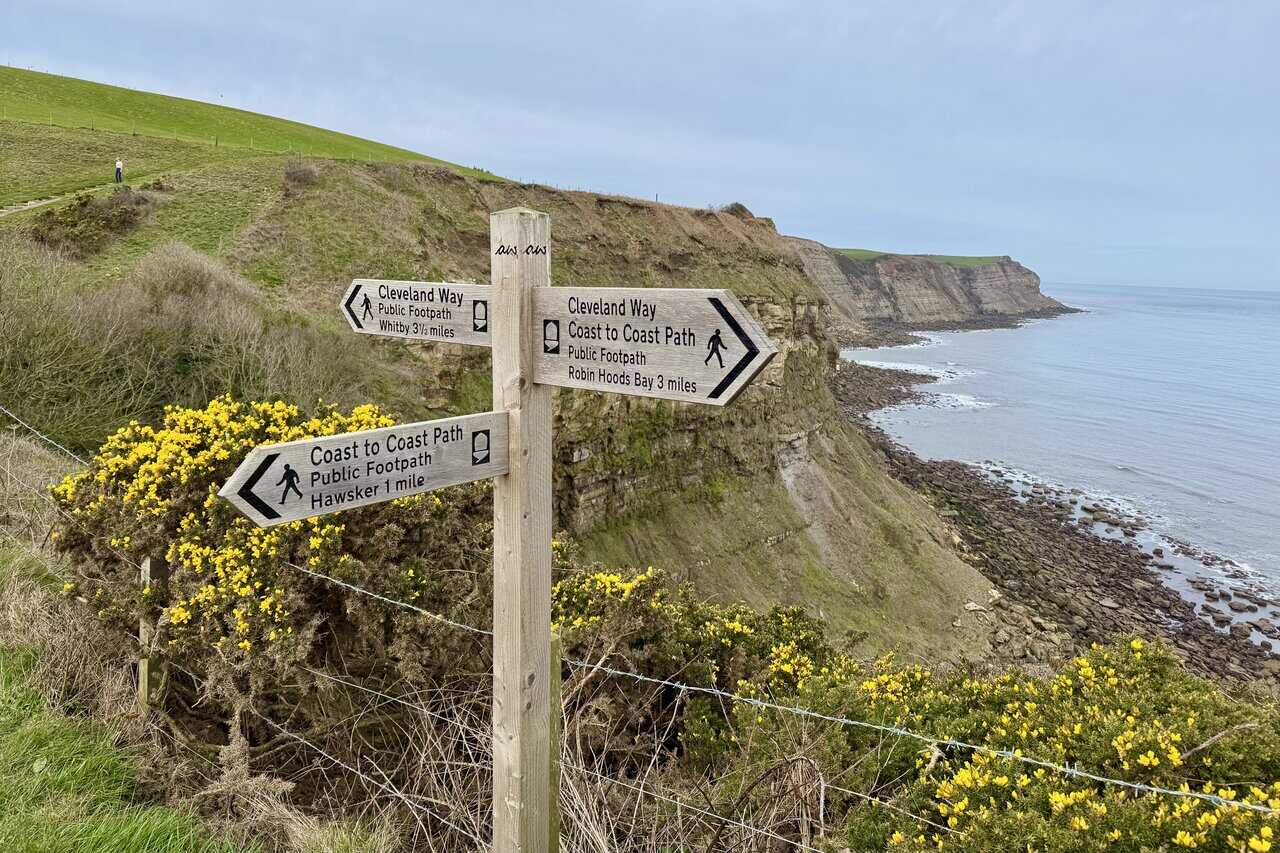 Coast to Coast and Cleveland Way signpost near Northcliffe Holiday Park on the Robin Hood's Bay walk.
