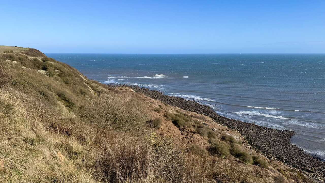 Flagstone paths on the Runswick Bay walk and steps winding steeply between cottages in Lower Runswick, creating a layered, maze-like village scene.