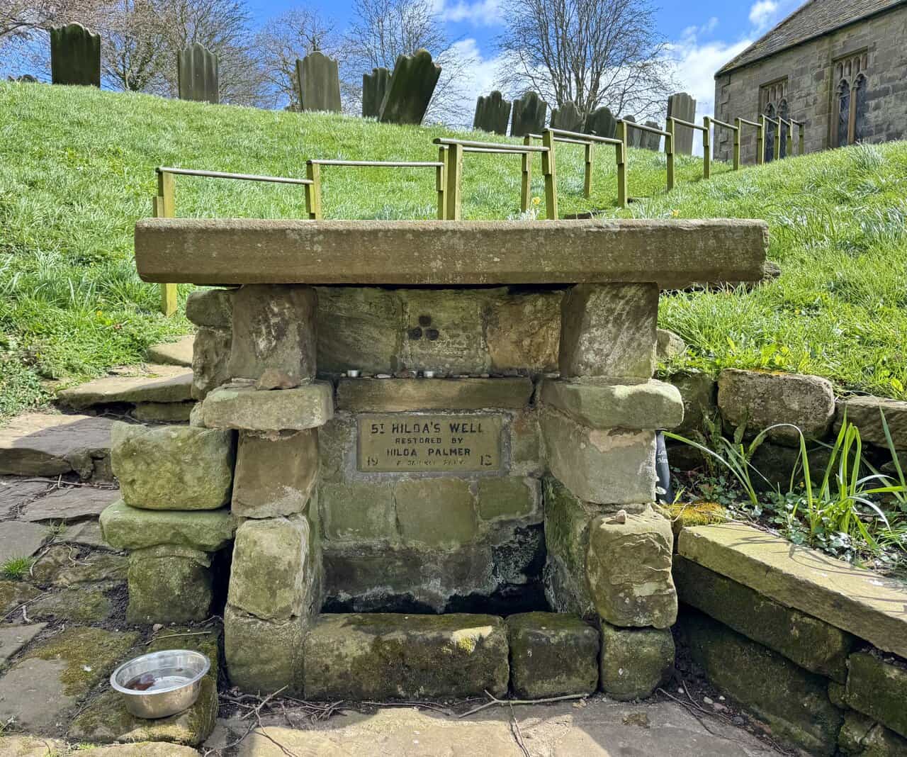 St Hilda’s Well on the Runswick Bay walk, a small stone-built structure with plaque, set into the hillside below the churchyard.