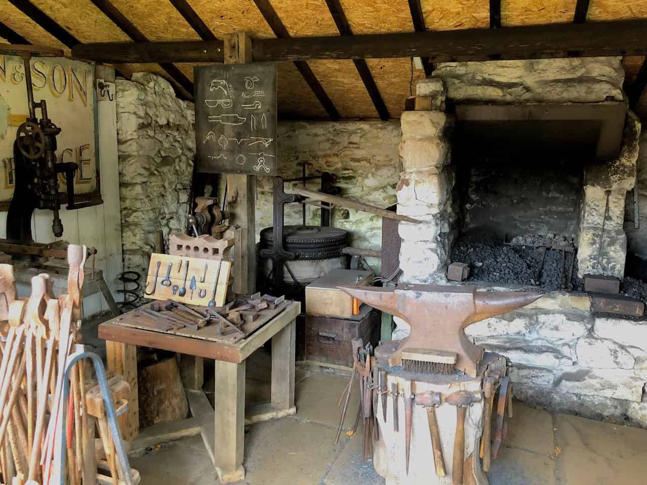 The hooping plate outside the Blacksmith's Forge at Ryedale Folk Museum, used to fit metal rims onto wooden wheels by heating the tyre until it expanded and then dousing it with cold water to contract it into a tight fit.