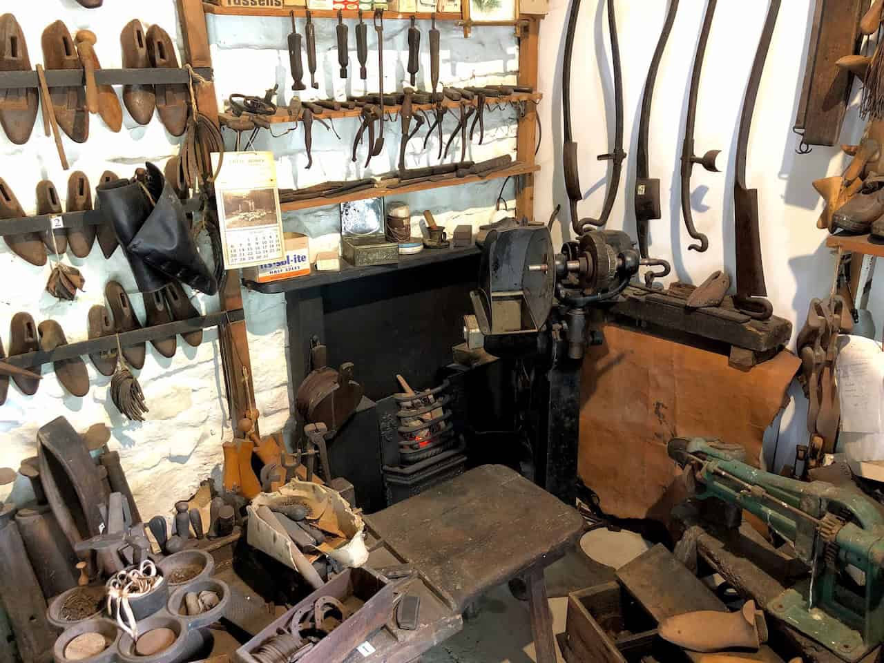 The Cobbler's Shop at Ryedale Folk Museum, displaying the tools and benches used to make and repair traditional footwear, including sturdy clogs for farm work, with lasts and awls among the historic equipment on show.